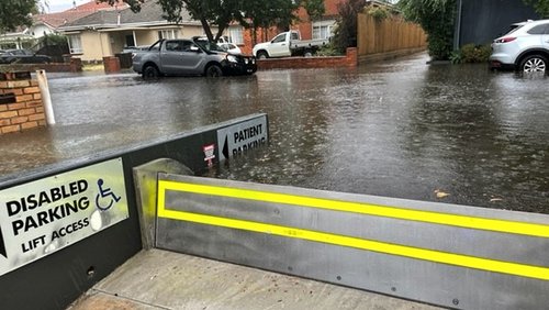 76aab05ceb96-flood_free_commercial_tilting_flood_barrier_deployed_2